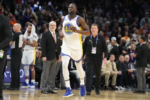 Golden State Warriors forward Draymond Green (23) jogs off the court after getting ejected during the second half of an NBA basketball game against the Phoenix Suns, Tuesday, Dec. 12, 2023, in Phoenix. (AP Photo/Rick Scuteri)