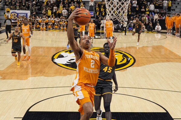 Tennessee guard Jordan Gainey (2) gets past Missouri center Mabor Majak (45) to put up a shot during the first half of an NCAA college basketball game Tuesday, Feb. 20, 2024, in Columbia, Mo. (AP Photo/Charlie Riedel)