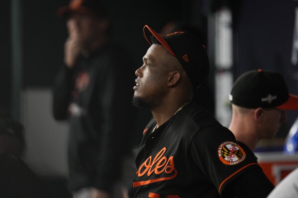 Baltimore Orioles relief pitcher Yennier Cano stands in the dugout after the Texas Rangers defeated the Orioles in Game 3 of a baseball AL Division Series on Tuesday, Oct. 10, 2023, in Arlington, Texas. (AP Photo/Julio Cortez)