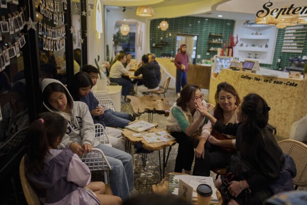 Customers chat while waiting for their orders at a cafe in the Little Saigon neighborhood of Westminster, Calif., Tuesday, April 22, 2025.(AP Photo/Jae C. Hong)