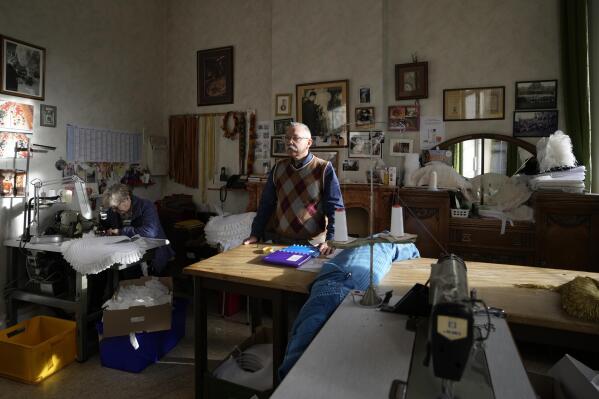 Karl Kersten, right, and his wife Beatrice inside the family costume workshop in Binche, Belgium, Wednesday, Feb. 1, 2023. After a COVID-imposed hiatus, artisans are putting finishing touches on elaborate costumes and floats for the renowned Carnival in the Belgian town of Binche, a tradition that brings together young and old and is a welcome moment of celebration after a rough few years. (AP Photo/Virginia Mayo)