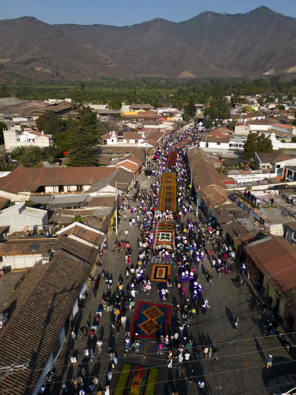 Faithful walk beside sawdust carpets during Holy Week celebrations in Antigua, Guatemala, on Good Friday, March 29, 2024. (AP Photo/Moises Castillo)