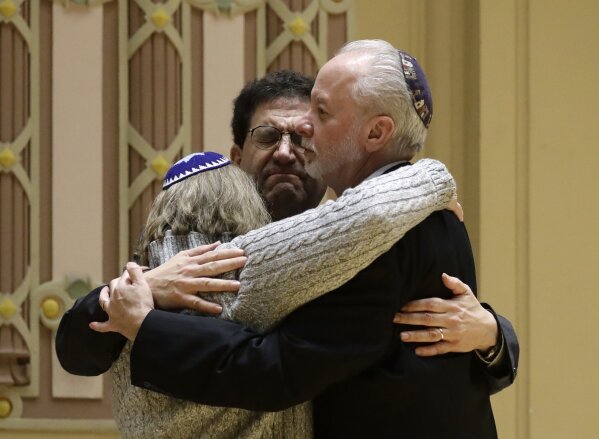 
              Rabbi Jeffrey Myers, right, of Tree of Life/Or L'Simcha Congregation hugs Rabbi Cheryl Klein, left, of Dor Hadash Congregation and Rabbi Jonathan Perlman during a community gathering held in the aftermath of a deadly shooting at the Tree of Life Synagogue in Pittsburgh, Sunday, Oct. 28, 2018. (AP Photo/Matt Rourke)
            