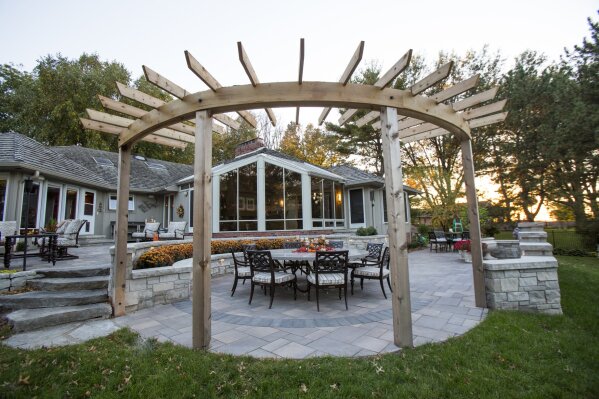 
              This September 2016 photo taken in an Omaha, Neb. neighborhood shows a pergola and how they are increasingly being used to shade outdoor entertainment areas. The overhead structures historically were used to protect walkways in gardens. (Colin Conces/Sun Valley Landscaping via AP)
            