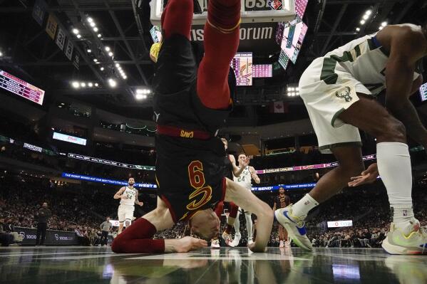 Cleveland Cavaliers' Dylan Windler lands on his head after going for a shot during the first half of an NBA basketball game against the Milwaukee Bucks Saturday, Dec. 18, 2021, in Milwaukee. (AP Photo/Morry Gash)