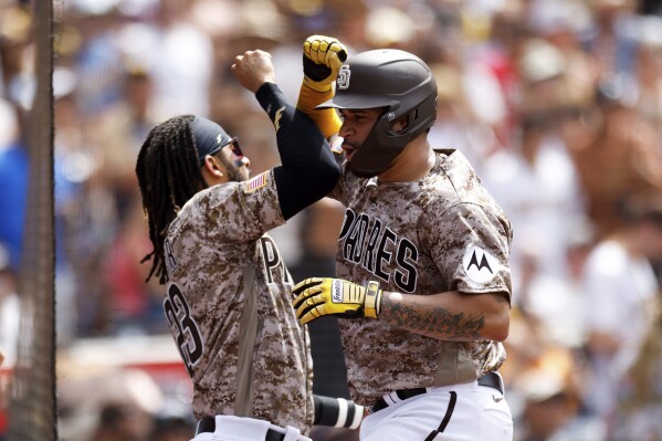 San Diego Padres' Gary Sanchez, right, celebrates with Fernando Tatis Jr. after hitting a solo home run against the Texas Rangers in the fifth inning of a baseball game Sunday, July 30, 2023, in San Diego. (AP Photo/Derrick Tuskan)