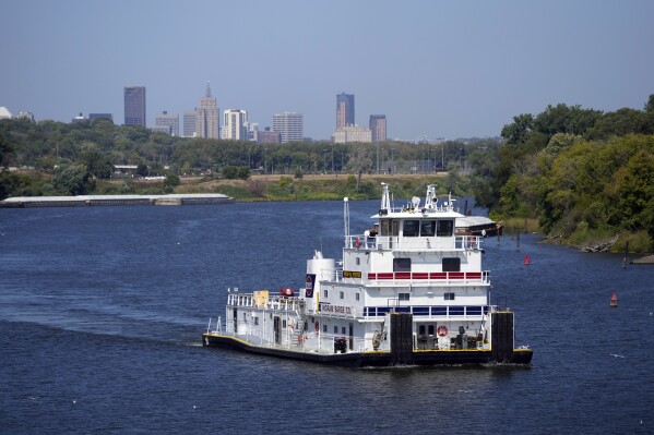 A towing ship travels south down the Mississippi River Thursday, Sept. 14, 2023, in St. Paul, Minn. A long stretch of hot, dry weather has left the Mississippi River so low that barge companies are reducing their loads as shipping costs soar. (AP Photo/Abbie Parr)