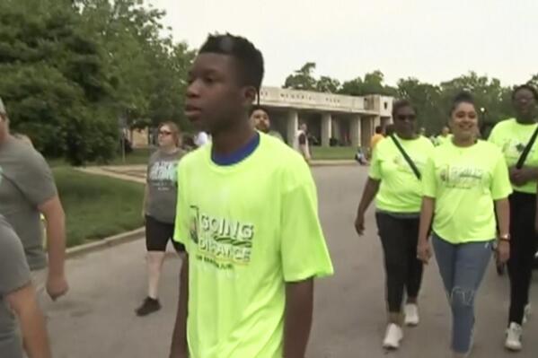 In this image made from video provided by KCTV, Ralph Yarl, center, wearing a bright green 