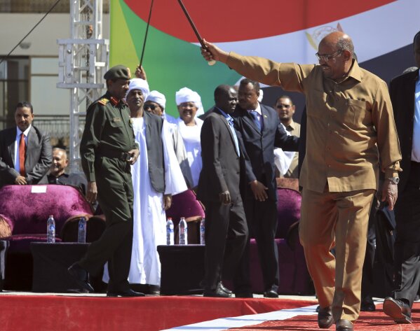 
              FILE - In this Wednesday, Jan. 9, 2019 file photo, Sudanese President Omar al-Bashir greets his supporters at a rally in Khartoum, Sudan. Sudan's armed forces were to deliver an "important statement" and asked the nation to "wait for it" on Thursday, April 11, 2019, state TV reported, as two senior officials said the military had forced longtime President Omar al-Bashir to step down. (AP Photo/Mahmoud Hjaj, File)
            