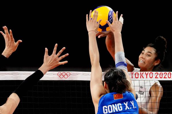 United States' Jordan Thompson, right, hits the ball during the women's volleyball preliminary round pool B match between China and United States at the 2020 Summer Olympics, Tuesday, July 27, 2021, in Tokyo, Japan. (AP Photo/Frank Augstein)