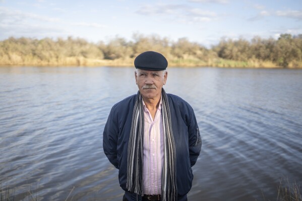 Mimoun Nadori poses for a portrait in front of the Moulouya River, in Nador, Morocco, Friday, March 8, 2024. (AP Photo/Mosa'ab Elshamy)