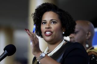 FILE — Boston NAACP Branch President Tanisha Sullivan faces reporters during a news conference, Thursday, Dec. 12, 2019, in Boston. Sullivan said Tuesday, Jan. 18, 2022, she is running for the Democratic nomination for Massachusetts secretary of the commonwealth. Sullivan said in a campaign video that she'll work to expand voting rights and make public records more accessible. (AP Photo/Steven Senne, File)