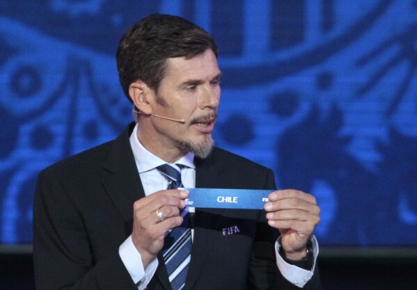 FILE - Zvonimir Boban, FIFA's Deputy Secretary General for Football, holds the lot of Chile during the draw for the soccer Confederations Cup 2017, in Kazan, Russia, on Nov. 26, 2016. Turmoil inside European soccer body UEFA fueled by its president Aleksander Ceferin’s push to change statutes to let him stay in office longer has led to a first exit of a senior manager. Zvonimir Boban cited his “total disapproval” for Ceferin’s political power move in resigning as UEFA Chief of Football. The former Croatia and AC Milan great was in the job for three years. Boban says he has “no option but to leave UEFA” and is "not alone in my thinking here.” Boban’s departure is the most public show of growing discontent with Ceferin’s leadership in recent months. (AP Photo/Ivan Sekretarev, File)