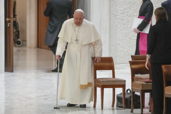 Pope Francis arrives in the Paul VI hall on the occasion of the weekly general audience at the Vatican, Wednesday, Dec. 13, 2023. (AP Photo/Gregorio Borgia)