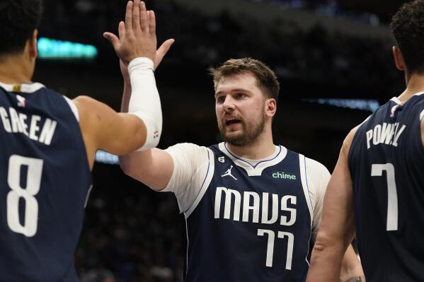 Dallas Mavericks guard Luka Doncic (77) and teammate Josh Green (8) celebrate during the second half of an NBA basketball game against the Miami Heat in Dallas, Friday, Jan. 20, 2023. AP Photo/LM Otero)