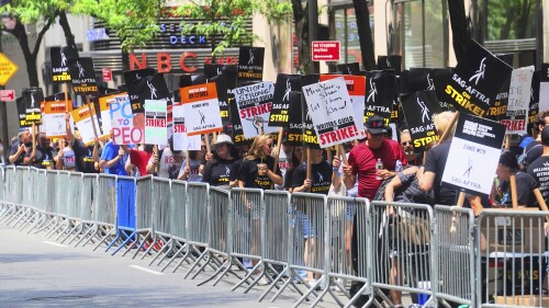 Writers and actors join forces as they walk the picket line during a strike, Friday, July 14, 2023, at NBC Universal Studios in New York. The picketing comes a day after the main actors’ union voted to join screenwriters in a double-barreled strike for the first time in more than six decades. The dispute immediately shut down production across the entertainment industry after talks for a new contract with studios and streaming services broke down. (AP Photo/Bebeto Matthews)