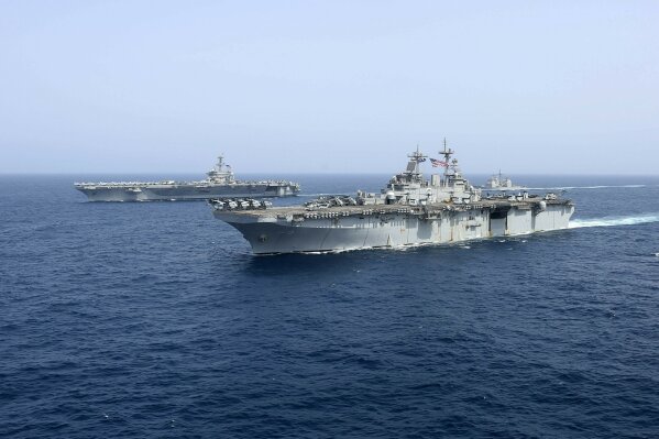 
              CORRECTS DATE - In this Friday, May 17, 2019, photo released by the U.S. Navy, the amphibious assault ship USS Kearsarge sails in front of the USS Abraham Lincoln aircraft carrier in the Arabian Sea. Commercial airliners flying over the Persian Gulf risk being targeted by "miscalculation or misidentification" from the Iranian military amid heightened tensions between the Islamic Republic and the U.S., American diplomats warned Saturday, May 18, 2019, even as both Washington and Tehran say they don't seek war. (Mass Communication Specialist 1st Class Brian M. Wilbur, U.S. Navy via AP)
            