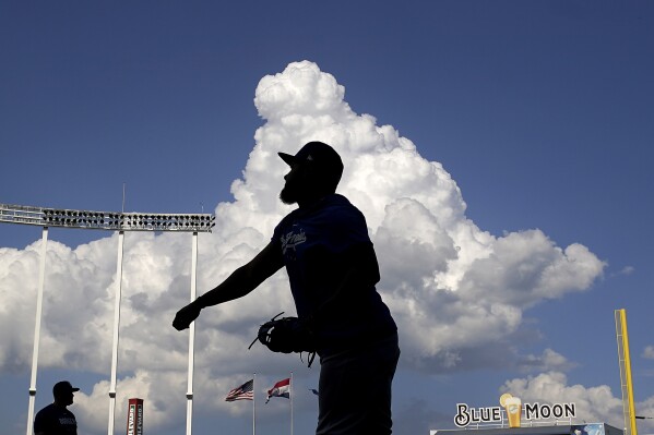 Los Angeles Dodgers third baseman Yonny Hernandez warms up before a baseball game against the Kansas City Royals Friday, June 30, 2023, in Kansas City, Mo. (AP Photo/Charlie Riedel)