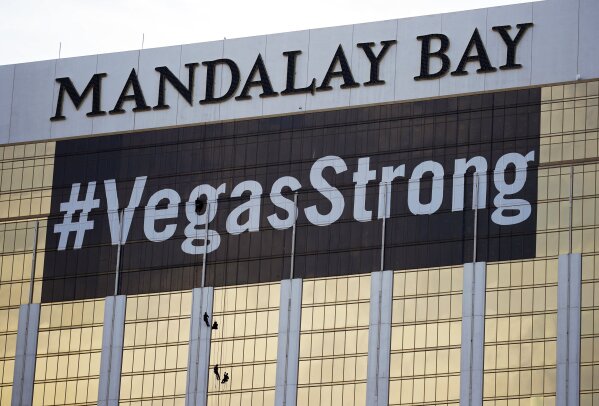 
              FILE - In this Monday, Oct. 16, 2017, file photo, workers install a #VegasStrong banner on the Mandalay Bay hotel and casino in Las Vegas. Stephen Paddock opened fire from the hotel on an outdoor country music concert, killing 58 and injuring hundreds. Las Vegas' efforts to rebrand itself since the shooting show just how difficult it can be for organizations to hit the right tone after a deeply tragic event. The city put its famous "What happens here, stays here" slogan on hold, and its initial ad campaign after the attack won praise for its sensitivity. But a national TV commercial that features real social media posts from after the shooting is getting more mixed reviews, with some calling it tacky.(AP Photo/John Locher, File)
            