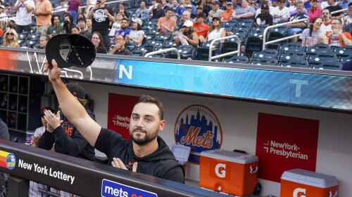 San Francisco Giants right fielder and former New York Mets player Michael Conforto acknowledges the fans' applause as he is introduced on the large television, before a baseball game Friday, June 30, 2023, in New York. (AP Photo/Mary Altaffer)