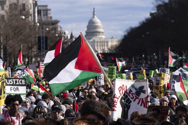 FILE - With the U.S Capitol in the background, demonstrators rally during the March on Washington for Gaza at Freedom Plaza in Washington, Jan. 13, 2024. About half of Asian Americans, Native Hawaiians and Pacific Islanders in the U.S. believe the country is giving too much support of Israelis and not enough for Palestinians amid the ongoing war in Gaza, according to a new poll that shows those views are dominant among young adults. (AP Photo/Jose Luis Magana, File)