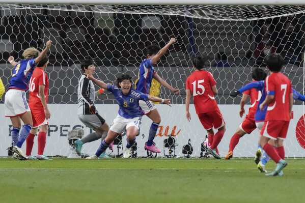 Japan's Hana Takahashi, centre, celebrates after scoring the first goal for her side during the final qualifier for the Paris Olympic women's football tournament between Japan and North Korea at the National Stadium Wednesday, Feb. 28, 2024, in Tokyo. (AP Photo/Eugene Hoshiko)