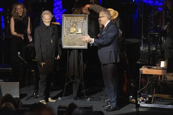 Kris Kristofferson, left, stands with the plaque of honoree Jerry Lee Lewis during the Country Music Hall of Fame Medallion Ceremony on Sunday, Oct. 16, 2022, at the Country Music Hall of Fame in Nashville, Tenn. (Photo by Wade Payne/Invision/AP)