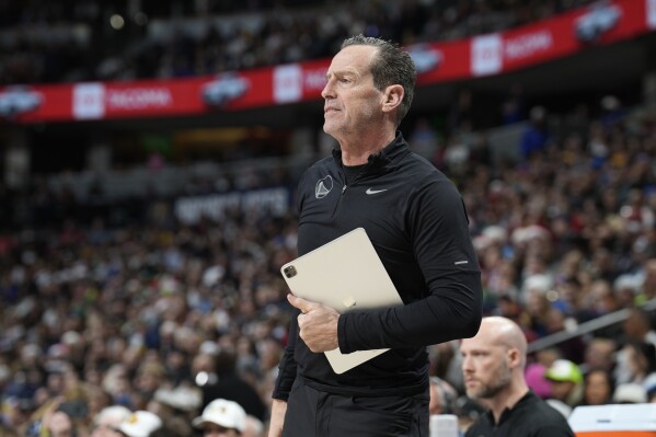 FILE - Golden State Warriors assistant coach Kenny Atkinson watches during the first half of the team's NBA basketball game against the Denver Nuggets on Dec. 25, 2023, in Denver. The Cleveland Cavaliers have received permission to interview Atkinson and New Orleans assistant James Borrego for their head coaching vacancy, a person familiar with the process told the Associated Press on Wednesday night, May 29. (AP Photo/David Zalubowski, File)