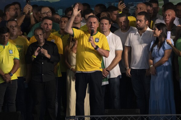 Brazil's former President Jair Bolsonaro speaks at the launch of the pre-candidacy of Alexandre Ramagem, center right, for the Rio de Janeiro's mayoral elections in Rio de Janeiro, Brazil, Saturday, March 16, 2024. (AP Photo/Silvia Izquierdo)