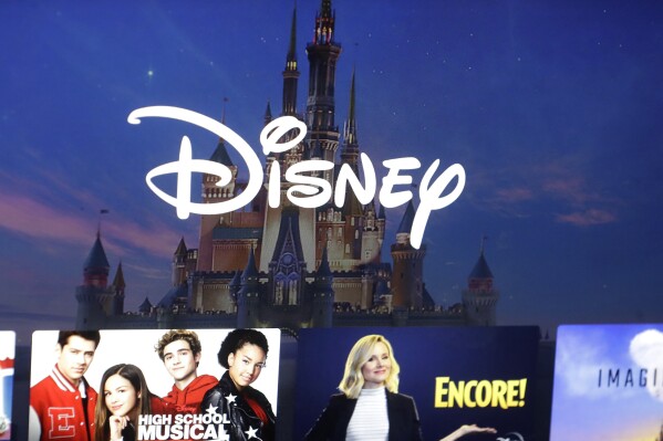FILE - A Disney logo forms part of a menu for the Disney Plus movie and entertainment streaming service on a computer screen in Walpole, Mass, Nov. 13, 2019. Walt Disney's moved to a loss in its second quarter, hampered by significantly higher restructuring and impairment charges, but its streaming business was profitable and theme parks continued to be a strength. While The Walt Disney Co. said Tuesday, May 7, 2024, that it foresees its streaming business softening in the third quarter due to Disney+Hotstar, it expects its combined streaming businesses to be profitable in the fourth quarter and to be a meaningful future growth driver for the company, with further improvements in profitability in fiscal 2025. (AP Photo/Steven Senne, File)