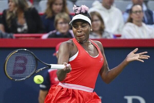 Venus Williams, of the United States, plays a shot during her women's first-round match against Madison Keys, also of the United States, at the National Bank Open tennis tournament in Montreal, Monday, Aug. 7, 2023. (Graham Hughes/The Canadian Press via AP)