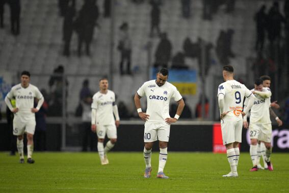 Marseille players react at the end of the French League One soccer match between Marseille and Paris Saint-Germain at the Velodrome stadium in Marseille, southern France, Sunday, Feb. 26, 2023. (AP Photo/Daniel Cole)