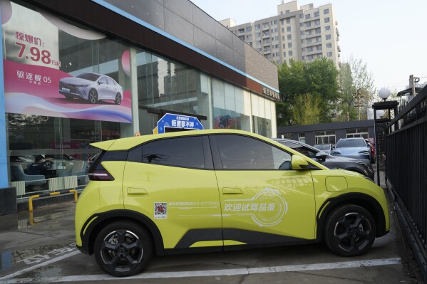 A Seagull electric vehicle from Chinese automaker BYD for test driving is parked outside a showroom in Beijing, Wednesday, April 10, 2024. The tiny, low-priced electric vehicle called the Seagull has American automakers and politicians trembling. The car, launched last year by Chinese automaker BYD, sells for around $12,000 in China. But it drives well and is put together with craftsmanship that rivals U.S.-made electric vehicles that cost three times as much. Tariffs on imported Chinese vehicles probably will keep the Seagull away from America’s shores for now.(AP Photo/Ng Han Guan)