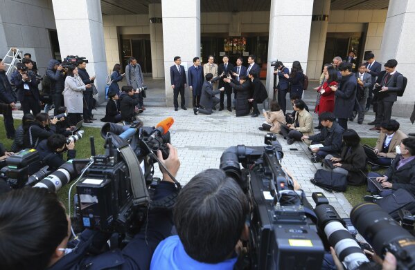 
              Oh Seung-hun, top center, speaks to the media after a court's verdict to overturn his conviction on refusing to do mandatory military service, at the Supreme Court in Seoul, South Korea, Thursday, Nov. 1, 2018. In a landmark verdict, South Korea's top court on Thursday ruled that people can legally reject mandatory military service on conscientious or religious grounds and must not be punished. (AP Photo/Ahn Young-joon)
            
