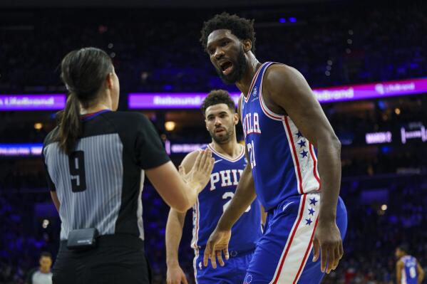 Philadelphia 76ers' Joel Embiid, right, argues the foul called against him by referee Natalie Sago, left, during the first half of an NBA basketball game against the New Orleans Pelicans, Monday, Jan. 2, 2023, in Philadelphia. (AP Photo/Chris Szagola)