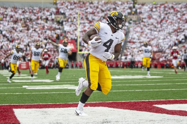 Iowa running back Leshon Williams (4) runs into the end zone for the opening touchdown of an NCAA college football game against Wisconsin, Saturday, Oct. 14, 2023, in Madison, Wis. (Geoff Stellfox/The Gazette via AP)