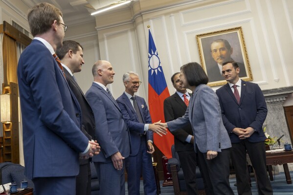 In this photo released by the Taiwan Presidential Office, Taiwan's President Tsai Ing-wen, second right, shakes hands with members of United States Congressmen as Rep. Mike Gallagher, the Republican chair of the House Select Committee on the Chinese Communist Party, right, looks on during a meeting in Taipei, Taiwan, Thursday, Feb. 22, 2024. A group of United States Congress members met with Taiwan's president Thursday in a show of support that's certain to draw scrutiny from China, which opposes such visits and sees them as a challenge to its claim of sovereignty over the island. (Taiwan Presidential Office via AP)