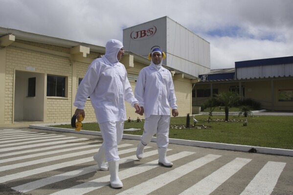 Employees walk on the plant grounds of meatpacker JBS, in Lapa, in the Brazilian state of Parana, March 21, 2017. (AP Photo/Eraldo Peres, File)