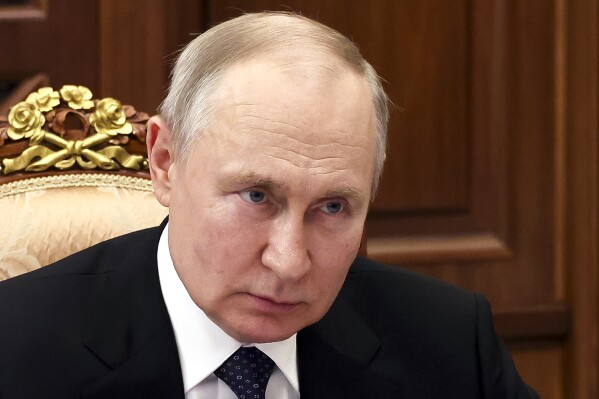Russian President Vladimir Putin listens to Irkutsk Region Governor Igor Kobzev, in Moscow, Russia, Monday, July 17, 2023. (Alexander Kazakov, Sputnik, Kremlin Pool Photo via AP)