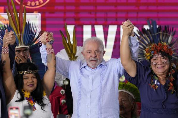 Brazilian President Luiz Inacio Lula da Silva, center, stands between Indigenous Peoples Minister Sonia Guajajara, left, and National Indigenous Foundation President Joenia Wapichana at the closing of the annual Terra Livre, or Free Land Indigenous Encampment in Brasilia, Brazil, Friday, April 28, 2023. (AP Photo/Eraldo Peres)