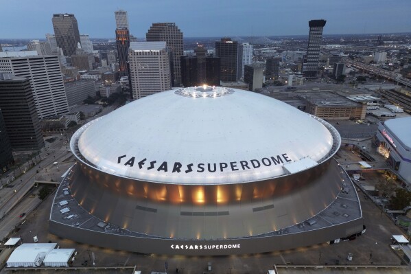 FILE - The Superdome stands with the New Orleans skyline in the background after an NFL football game between the New Orleans Saints and the Atlanta Falcons, Jan. 7, 2024, in New Orleans. The state commission that oversees the Superdome and the Saints are at odds over the club's contribution to the costs of renovations scheduled for completion before the stadium hosts the next Super Bowl. (AP Photo/Tyler Kaufman, File)