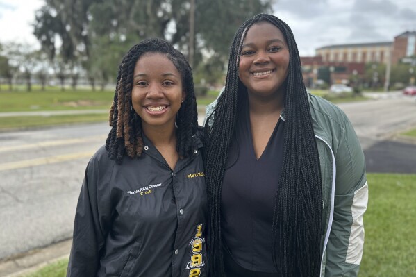Founders of the Florida AM organization 'Rattlers Pack' Cayla Goff and Karen Moses head to their next meeting on campus on Sept. 27, 2023 in Tallahassee, Fla. A core mission of Florida A&M University from its founding over a century ago has been to educate African Americans. It was written into the law that established the school along with another college, in Gainesville, reserved for white students. At Florida's only public HBCU, some students now fear political constraints might get in the way of teaching parts of their history. (AP Photo/Sharon Johnson)