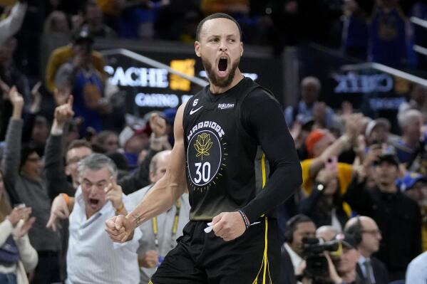Golden State Warriors guard Stephen Curry (30) celebrates after making a 3-point basket during the second half of an NBA basketball game against the Milwaukee Bucks in San Francisco, Saturday, March 11, 2023. (AP Photo/Jeff Chiu)