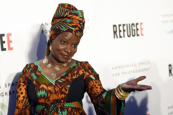 FILE - In this Thursday, April 21, 2016, file photo, singer and UNICEF Goodwill Ambassador Angelique Kidjo poses at the opening of the new photography exhibit "REFUGEE" at The Annenberg Space for Photography in Los Angeles. Kidjo uses her artistry and her activism to connect beyond language and skin color. Kidjo and other international musicians are performing social justice anthems for an online fundraising concert called Peace Through Music: A Global Event for Social Justice. (Photo by Chris Pizzello/Invision/AP, File)