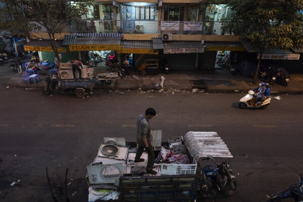 Waste workers load casings of various home appliances onto their trucks in Nhat Tao market, the largest informal recycling market in Ho Chi Minh City, Vietnam, Monday, Jan. 29, 2024. Less than a quarter of electronic waste was properly collected and recycled in 2022. (AP Photo/Jae C. Hong)