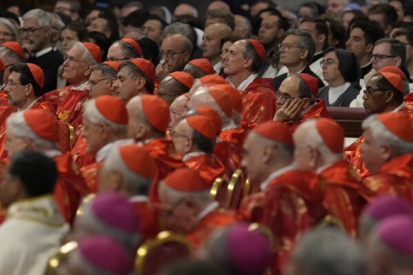 Cardinals, in red beretta hats, attend a final Mass celebrated by cardinals inside St. Peter's Basilica, before the conclave to elect a new pope, at the Vatican, Wednesday, May 7, 2025. (AP Photo/Gregorio Borgia)