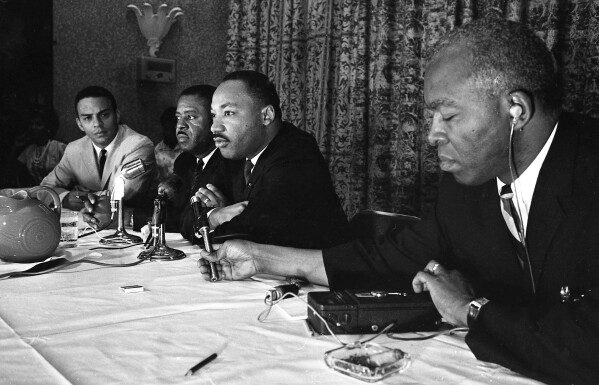 FILE - The Rev. Martin Luther King, center, speaks with the media at the Southern Christian Leadership Conference convention in Savannah, Ga., on Sept. 29, 1964. The March on Washington of 1963 was the product of sustained activism by broad coalition. The Black Church was not monolithic then nor now. (Savannah Morning News via AP, File)