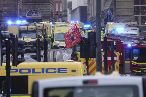 Police and emergency personnel deal with an incident near the Liver Building during the Premier League winners parade in Liverpool, England, Monday, May 26, 2025.(AP Photo/Jon Super)