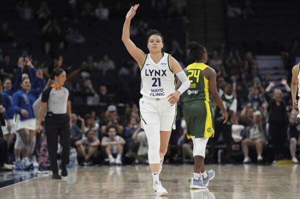 Minnesota Lynx guard Kayla McBride (21) gestures after making a 3-point basket during the second half of a WNBA basketball game against the Seattle Storm, Sunday, June 9, 2024, in Minneapolis. (AP Photo/Abbie Parr)
