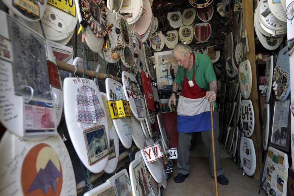 In this Wednesday, May 16, 2018, photo, retired plumber Barney Smith, 96, walks through his Toilet Seat Art Museum in Alamo Heights, Texas. Smith, called "King of the Commode," began his commode art work in 1992 and is looking for a buyer who will preserve his collection intact. (AP Photo/Eric Gay)